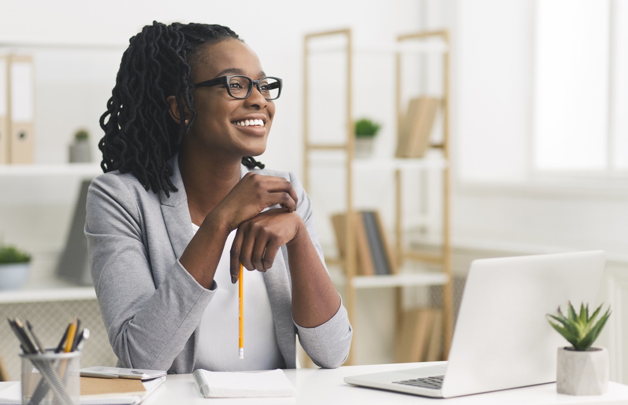 Young Afro Business Lady Smiling Sitting In Modern Office